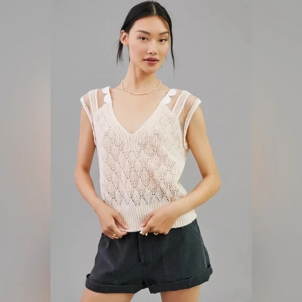 Anthropologie’s Maeve cream knit tank with sheer sleeves